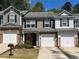 Well-maintained townhouse exterior with garages and manicured lawns at 4036 Carlinswood Way, Stone Mountain, GA 30083