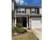 Charming townhome exterior with a white garage door, landscaping, and inviting entrance at 4036 Carlinswood Way, Stone Mountain, GA 30083