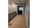 Hallway with carpet floors leading to a bedroom, showcasing the home's practical layout at 4036 Carlinswood Way, Stone Mountain, GA 30083