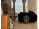 Cozy living room featuring plush seating, elegant decor, and stairs, creating a comfortable and stylish space at 4036 Carlinswood Way, Stone Mountain, GA 30083
