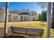 Large backyard featuring a classic swing set, lush green lawn, and the home's exterior at 4185 Waterford Dr, Suwanee, GA 30024