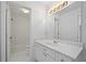A bathroom vanity with white cabinets and a view into a bright, clean shower and bathtub at 4185 Waterford Dr, Suwanee, GA 30024