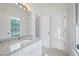 A bathroom vanity with granite countertops, a sink, and a view into a bright, clean bathroom at 4185 Waterford Dr, Suwanee, GA 30024