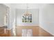 Formal dining room featuring hardwood floors, a chandelier, and a large window with an outside view at 4185 Waterford Dr, Suwanee, GA 30024