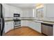 Kitchen features stainless steel appliances, white cabinets and granite countertops at 4185 Waterford Dr, Suwanee, GA 30024