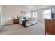 Spacious bedroom with neutral carpet, a ceiling fan, two windows and a walk-in closet at 2597 Oak Village Ne Pl, Marietta, GA 30062