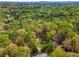 Aerial view of a home surrounded by lush, mature trees, providing privacy and a sense of tranquility at 388 Pine Trl, Canton, GA 30115