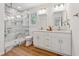 Bright bathroom featuring a marble shower, double vanity, and modern fixtures at 388 Pine Trl, Canton, GA 30115