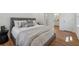 Neutral-toned bedroom with a comfortable bed, wood-look floors, and an ensuite bathroom at 388 Pine Trl, Canton, GA 30115