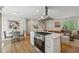 Open kitchen features a center island, stainless appliances, and a seamless transition to the dining and living areas at 388 Pine Trl, Canton, GA 30115