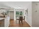 Eat-in kitchen shows a table setting in front of a door leading to a deck and views of surrounding lush greenery at 388 Pine Trl, Canton, GA 30115