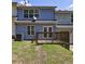Backyard view with a small wooden deck, some grass, and an air conditioning unit at 6340 Hickory Lane Cir, Union City, GA 30291
