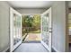French doors open to a spacious back porch with a view of lush greenery at 6340 Hickory Lane Cir, Union City, GA 30291