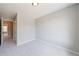 A light gray bedroom features plush carpeting with views of an adjoining room at 6340 Hickory Lane Cir, Union City, GA 30291