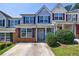 Charming townhome with a brick and siding exterior, manicured landscaping, and a private driveway at 6340 Hickory Lane Cir, Union City, GA 30291
