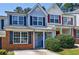 Charming townhome featuring brick accents, a covered porch, and well-maintained landscaping at 6340 Hickory Lane Cir, Union City, GA 30291