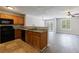 Inviting kitchen with wooden cabinets and black appliances, open to the living area at 6340 Hickory Lane Cir, Union City, GA 30291