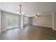 Open living room featuring hardwood floors, ceiling fan and glass patio doors at 6340 Hickory Lane Cir, Union City, GA 30291