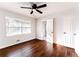 Bright bedroom with hardwood floors, ceiling fan, and large windows with natural light and a closet at 3036 Crabapple Cir, Decatur, GA 30034