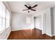 Bright bedroom with hardwood floors, ceiling fan, large window, and closet at 3036 Crabapple Cir, Decatur, GA 30034