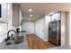 A modern kitchen featuring stainless steel appliances, gray cabinets, granite countertops, and a sleek black faucet at 3036 Crabapple Cir, Decatur, GA 30034