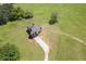 Aerial view of a spacious home with a long gravel driveway, surrounded by sprawling land and trees at 5187 Parkview Rd, Social Circle, GA 30025