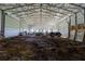 Spacious barn interior with metal roof supports and farm equipment parked on a dirt floor at 5187 Parkview Rd, Social Circle, GA 30025