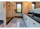 Bathroom featuring a walk-in shower, window, gray tile flooring and a vanity with a granite countertop at 5187 Parkview Rd, Social Circle, GA 30025