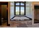 Luxurious bathroom features a soaking tub, a walk-in shower and a picture window at 5187 Parkview Rd, Social Circle, GA 30025