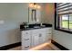 A bathroom features a vanity with a granite countertop, undermount sink, and travertine tile flooring at 5187 Parkview Rd, Social Circle, GA 30025