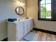 Well-lit bathroom with white vanity and a large arched window at 5187 Parkview Rd, Social Circle, GA 30025