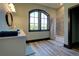 Bathroom featuring walk-in shower, vanity, and an arched window at 5187 Parkview Rd, Social Circle, GA 30025