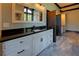 Elegant bathroom vanity with dark granite countertop, white cabinets, and stylish fixtures at 5187 Parkview Rd, Social Circle, GA 30025