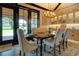 Elegant dining room featuring a stylish chandelier, custom built-ins, and picturesque outdoor views at 5187 Parkview Rd, Social Circle, GA 30025