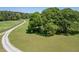 Gravel driveway leading to wooded property with a lush green lawn at 5187 Parkview Rd, Social Circle, GA 30025