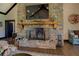 Stone fireplace with a rustic wood mantel, adding warmth and character to the living space at 5187 Parkview Rd, Social Circle, GA 30025