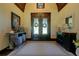 Elegant foyer with wood floors, decorative wreaths, and beautifully stained double front doors at 5187 Parkview Rd, Social Circle, GA 30025
