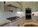 Gourmet kitchen featuring stainless appliances and designer tile backsplash at 5187 Parkview Rd, Social Circle, GA 30025