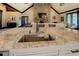 Granite countertop featured on large kitchen island complete with sink and faucet fixture at 5187 Parkview Rd, Social Circle, GA 30025