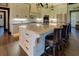 Gourmet kitchen with a large island, granite countertops, and stainless steel appliances at 5187 Parkview Rd, Social Circle, GA 30025