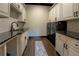 Well-equipped laundry room with granite counters, cabinetry and modern washer and dryer at 5187 Parkview Rd, Social Circle, GA 30025