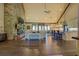 Spacious living room with a stone fireplace, hardwood floors, large windows, and an open-concept design at 5187 Parkview Rd, Social Circle, GA 30025