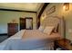 Relaxing bedroom with stone arch, tray ceiling, and access to the ensuite bathroom at 5187 Parkview Rd, Social Circle, GA 30025