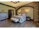 This bedroom boasts an eye-catching stone arch, decorative lighting and wood-look flooring at 5187 Parkview Rd, Social Circle, GA 30025