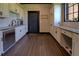 Well-lit mudroom featuring sleek stainless steel dishwasher and ample cabinetry at 5187 Parkview Rd, Social Circle, GA 30025