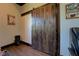 Office with barn door, desk, leather chair, and a wood floor at 5187 Parkview Rd, Social Circle, GA 30025