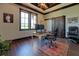 Office features a desk, rolling office chairs, a barn door, and a dual-pane window at 5187 Parkview Rd, Social Circle, GA 30025