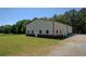 A large storage outbuilding sits on a well maintained yard with lush green grass at 5187 Parkview Rd, Social Circle, GA 30025