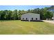 A large storage outbuilding sits on a well maintained yard with lush green grass at 5187 Parkview Rd, Social Circle, GA 30025