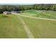 View of the horse barn, silos, outbuildings and pasture on a beautiful lot at 5187 Parkview Rd, Social Circle, GA 30025